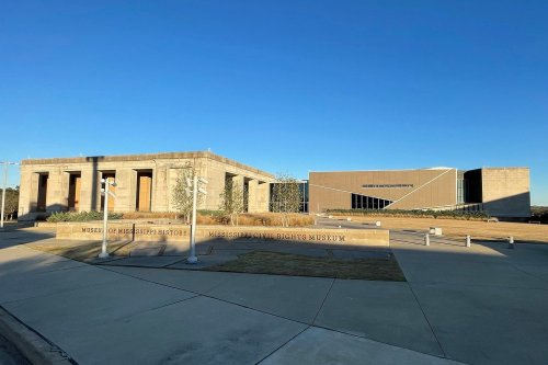 Exterior view of the Museum of Mississippi History and Mississippi Civil Rights Museum under a clear blue sky.