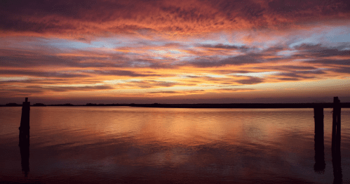 The sun has already dipped below the horizon leaving behind rich golden sunset hues on Daufuskie Island, SC