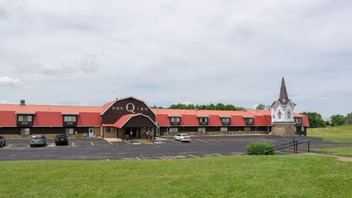 Exterior of the Don Q Inn, a long, historic inn with an orange roof