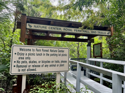 Sign at the entrance of Fern Forest Nature Center, detailing rules for visitors and picnic area information.