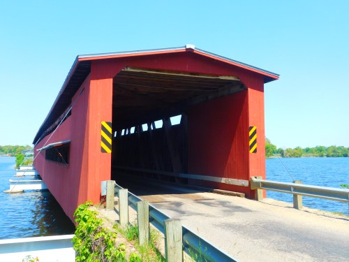 The opening of the Langley Covered Bridge in Michigan on a sunny day.