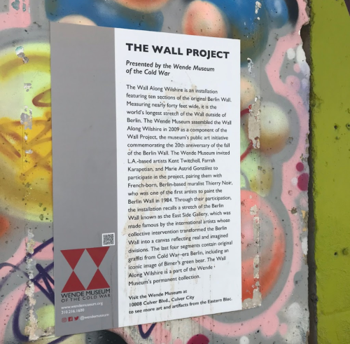 Sign for "The Wall Project" at the Wende Museum, detailing the history of the Berlin Wall and its significance.