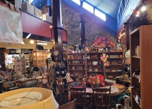 A cozy antique shop filled with various collectibles, shelves of decor, and a warm, inviting atmosphere.