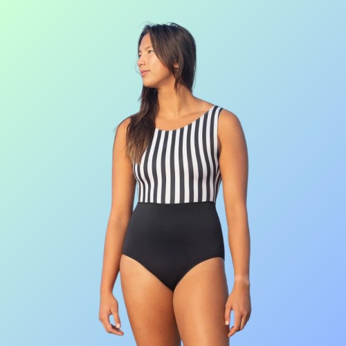 A woman in a black and white striped swimsuit poses against a gradient blue background.