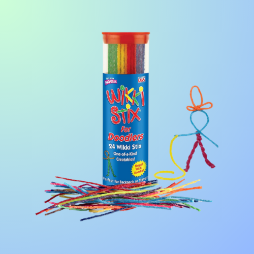 A colorful container of Wiki Stix with a few stix scattered and a figure made from the stix beside it.