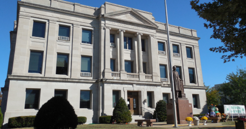 exterior of the county courthouse with a statue of former senator champ clark outside it in bowling green, missouri