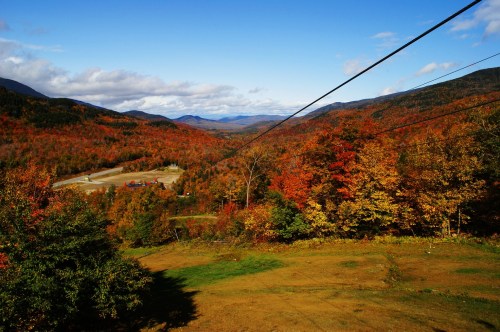 Zip line with a backdrop of spectacular mountain views of gorgeous fall foliage.
