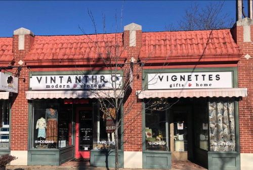 Two storefronts with red roofs: "Vintanthro" modern vintage and "Vignettes" gifts & home, both with large windows.