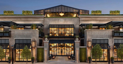 Modern building facade with large windows, greenery, and a stylish rooftop, featuring the initials "RH" prominently displayed.