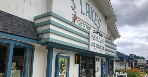 Exterior of the 3 Lakes Center for the Arts building, featuring a marquee and colorful signage.