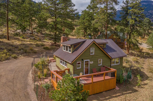 Aerial shot of a cute, green, vacation rental cabin near Estes Park, Colorado