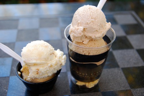 Two cups of ice cream: one with a scoop of vanilla and another with two scoops of coffee-flavored ice cream.