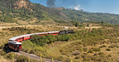 A steam engine travels through mountains near Chama, New Mexico.