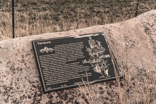 A plaque titled "Verdure" on a rock, detailing the history of the Blue Mountain settlement in the area.