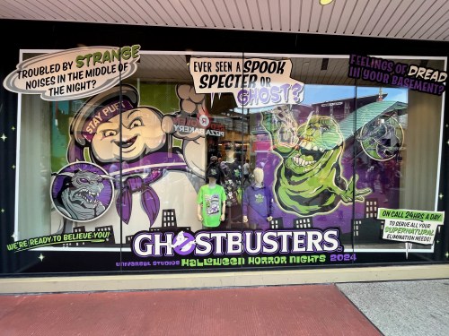 Window display for Ghostbusters at Universal Studios Halloween Horror Nights 2024, featuring characters and spooky themes.