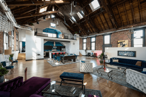 Open floorplan living, dining, and kitchen area in converted church vacation rental in Denver, Colorado