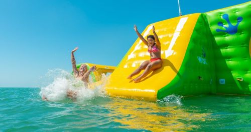 Person sliding down an inflatable slide at Key West, Florida's only ocean water park