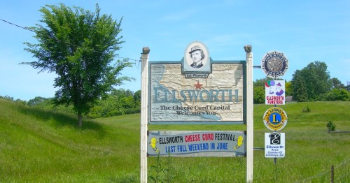 A sign declares Ellsworth, WI "The Cheese Curd Capital."