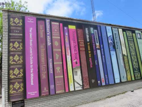 A multicolored mural depicting a shelf of books on the side of the Loganberry Books store in Cleveland, Ohio.