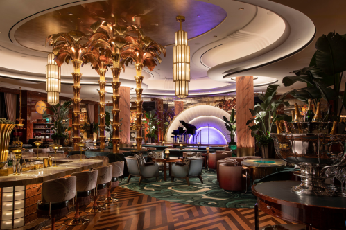 Interior of Delilah, a restaurant experience inside The Wynn, Las Vegas, showing seating, the bar, and the stage