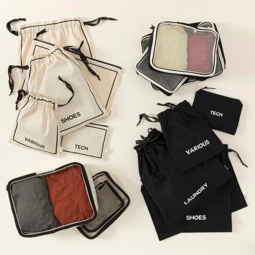 A collection of storage bags in various sizes and colors, labeled for shoes, laundry, tech, and various items.