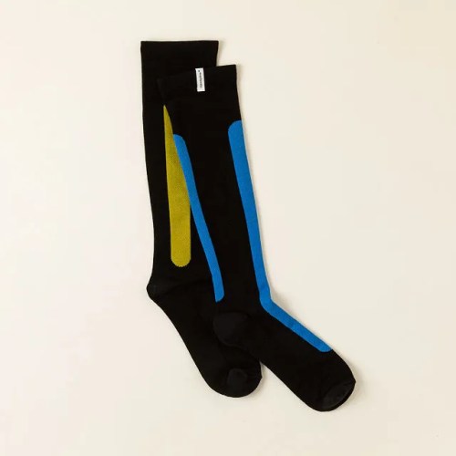 Black knee-high socks with blue and green accents, laid flat on a light background.