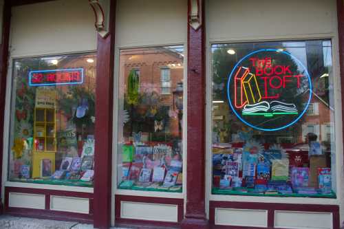 A shop storefront in Columbus, Ohio full of books with two neon signs declaring, "The Book Loft" and "32 rooms."