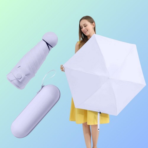 A woman in a yellow dress holds a white umbrella, with a purple case and a small purple item beside her.