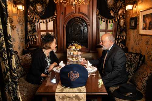 A sharply dressed couple enjoying teatime at St. James Tearoom in Albuquerque, New Mexico