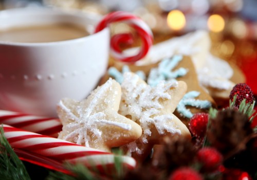 A cozy holiday scene featuring a cup of coffee, decorated snowflake cookies, and festive candy canes.