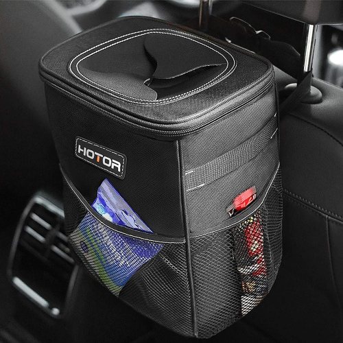 A black car trash can with a lid, hanging from a seat, featuring mesh pockets for storage.