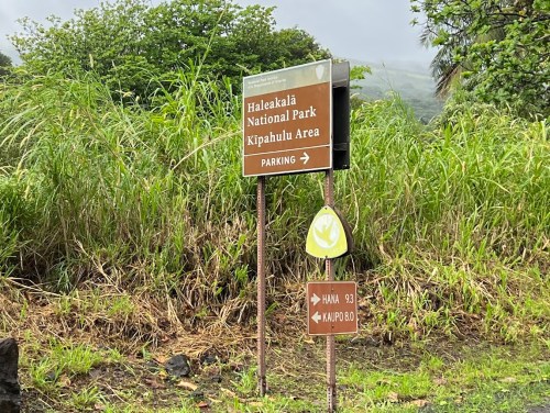 Sign for Haleakalā National Park, Kipahulu Area, with directions to parking and distances to Hana and Kaupo.