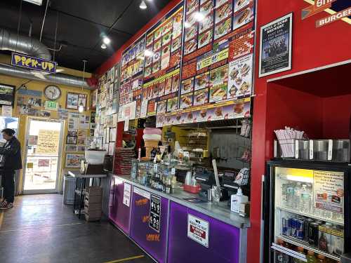 Interior shot of menu, cashier, and kitchen at Steve's Snappin' Dogs on Colfax Avenue in Denver, Colorado