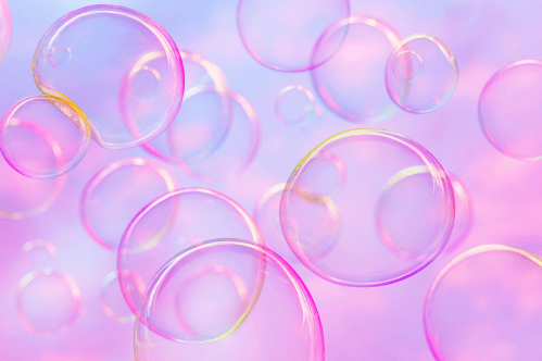 Colorful soap bubbles floating against a soft pastel background.