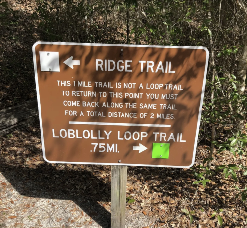 Sign indicating Ridge Trail and Loblolly Loop Trail directions, with distances of 1 mile and 0.75 miles, respectively.