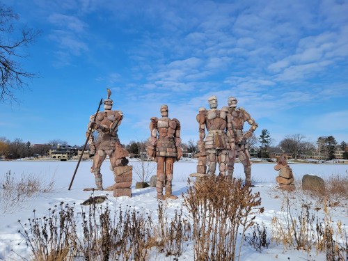Tall anthropomorphic rock statues stand in a snowy landscape in Illinois.