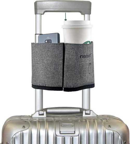 A gray luggage cup holder attached to a suitcase, holding a coffee cup and a smartphone.