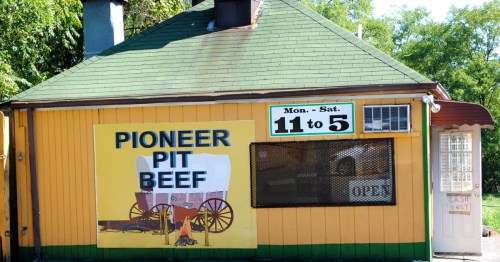 exterior of a small yellow building housing pioneer pit beef located in catonsviille maryland