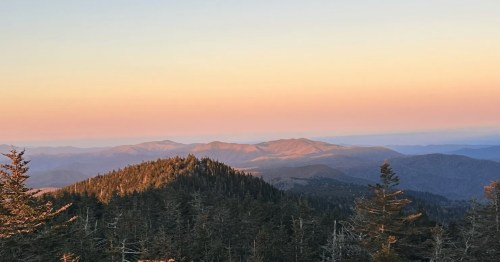 A beautiful sunset drapes the Smoky Mountains as seen from an iconic hiking trail in North Carolina.