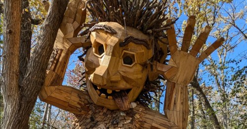 A large wooden troll sculpture at a small town park in Minnesota.