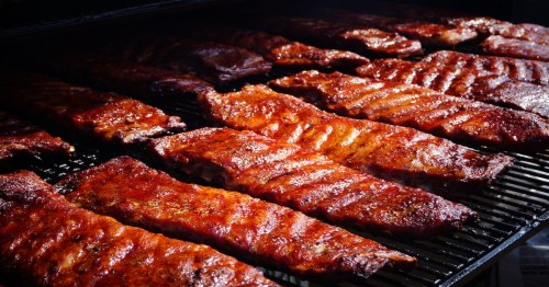 several bbq ribs on the grill