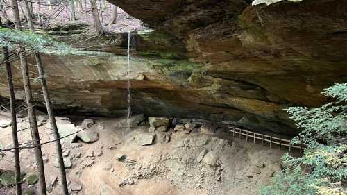 A soft, trickling stream of water falls from the top of Whispering Cave in Hocking Hills, Ohio.