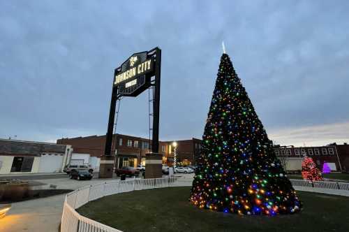 A massive Christmas tree in front of the Johnson City sign.