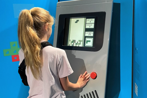 Child playing Game Boy at the Game Changers exhibit at the Cape Fear Museum