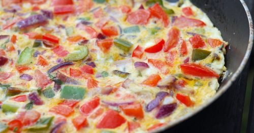 A close-up of an omelette in a pan.