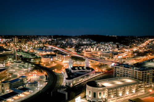 A view of downtown Worcester, Massachusetts at night. The roads and buildings are bright with lights.