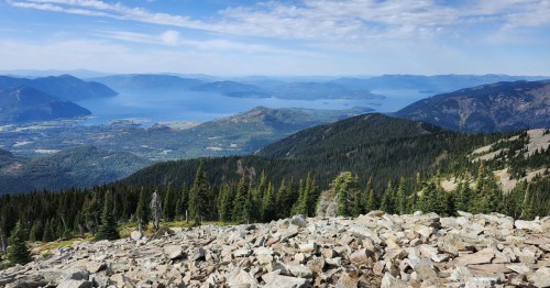 Looking toward a lake, mountains, and forest at the top of the Scotchman Peak Trail in northern Idaho.