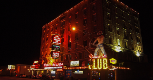 nightime shot of hotel nevada aglow with neon lights in ely, nevada
