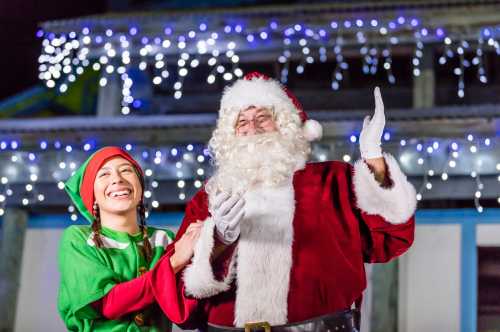 Santa and his helper smiling at Christmas