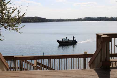 A wide patio opens up and leads down to a vast North Dakota lake framed by forest.